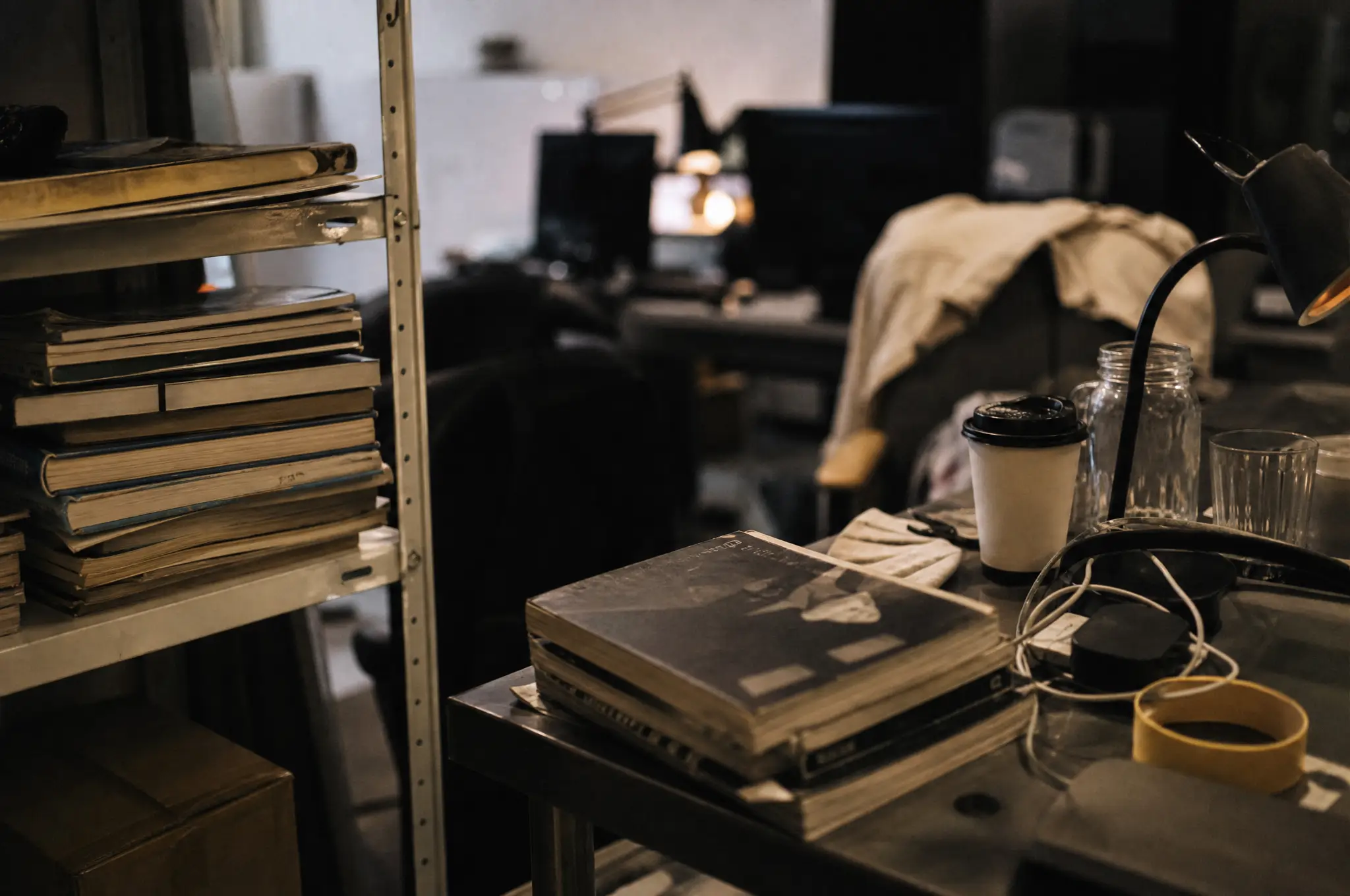 Design books, cables, and coffee in a working product studio