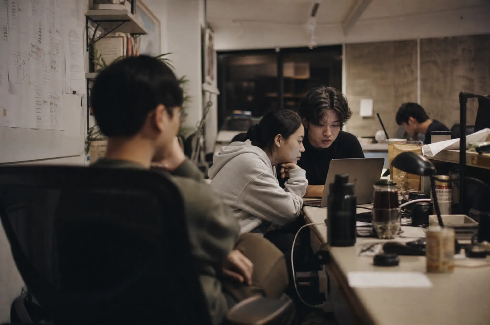 Product team gathered around a laptop during a working session